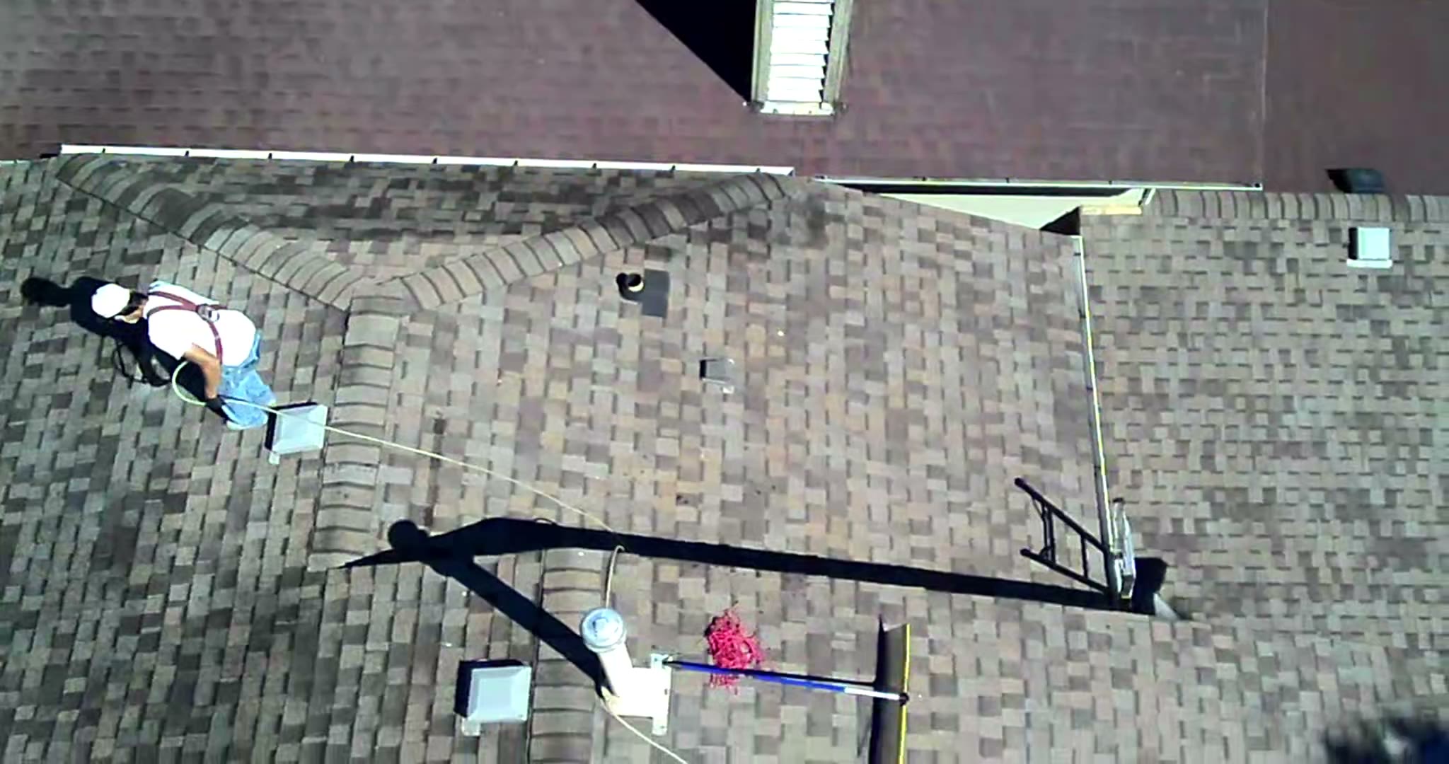Nano Shield crew member working on a shingle roof in Calgary